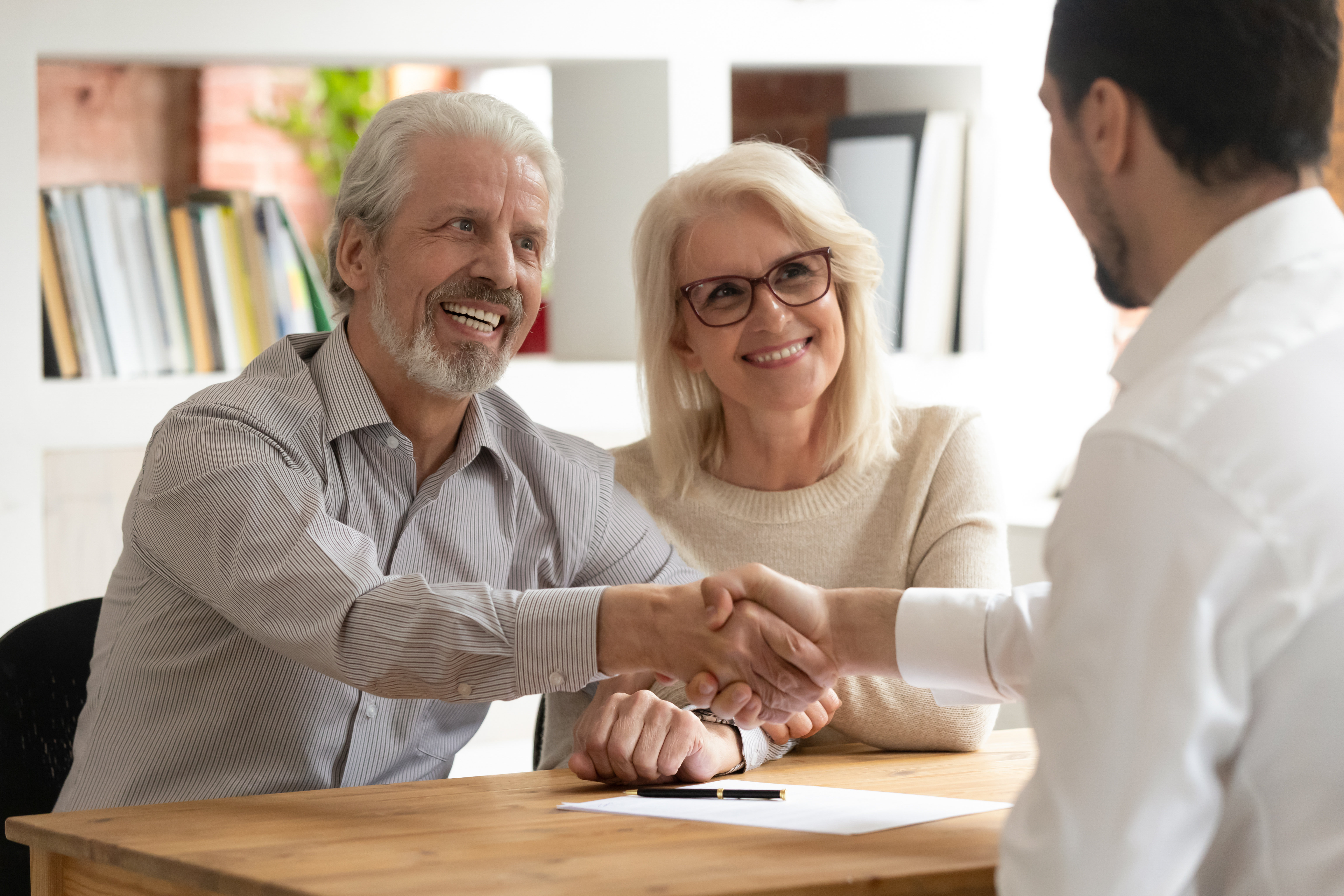 older couple meeting with attorney john nelson to do estate planning, wills, power of attorney and health card surrogate.